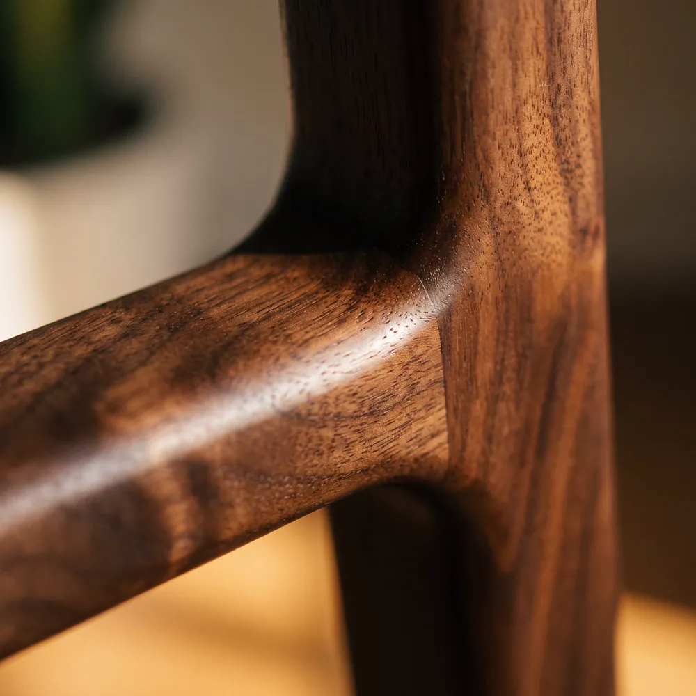 Close-up of a hand-finished walnut joint on a MYLADDER frame